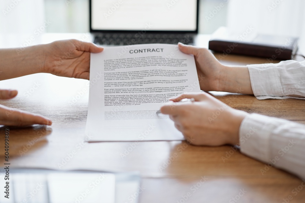 Businesswoman lawyer pointing into contract special points admitting something for colleague or client at the wooden desk in office. Business people teamwork and partnership, meeting concept. Businesswoman lawyer pointing into contract special points admitting something for colleague or client at the wooden desk in office. Business people teamwork and partnership, meeting concept.