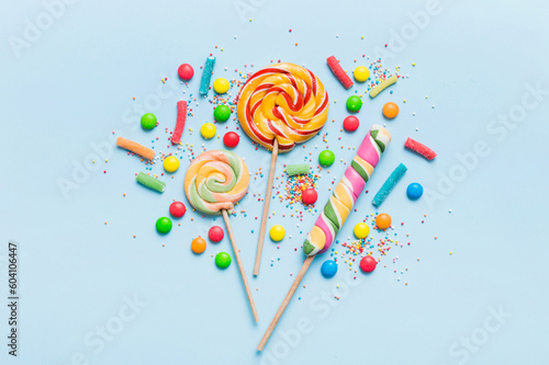 Tasty appetizing Party Accessories Happy Birthday Sweet. Different types of candies on colored background, copy space. Colorful birthday party background
