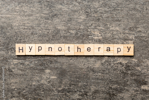 Hypnotherapy word written on wood block. Hypnotherapy text on cement table for your desing, concept photo