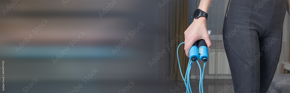 Young woman with a jump rope at home. Young woman with a jump rope at home.