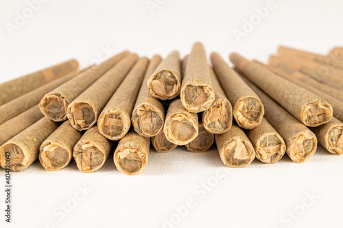 Stack of marijuana joint pre-rolled cone paper on white background, roll paper cannabis