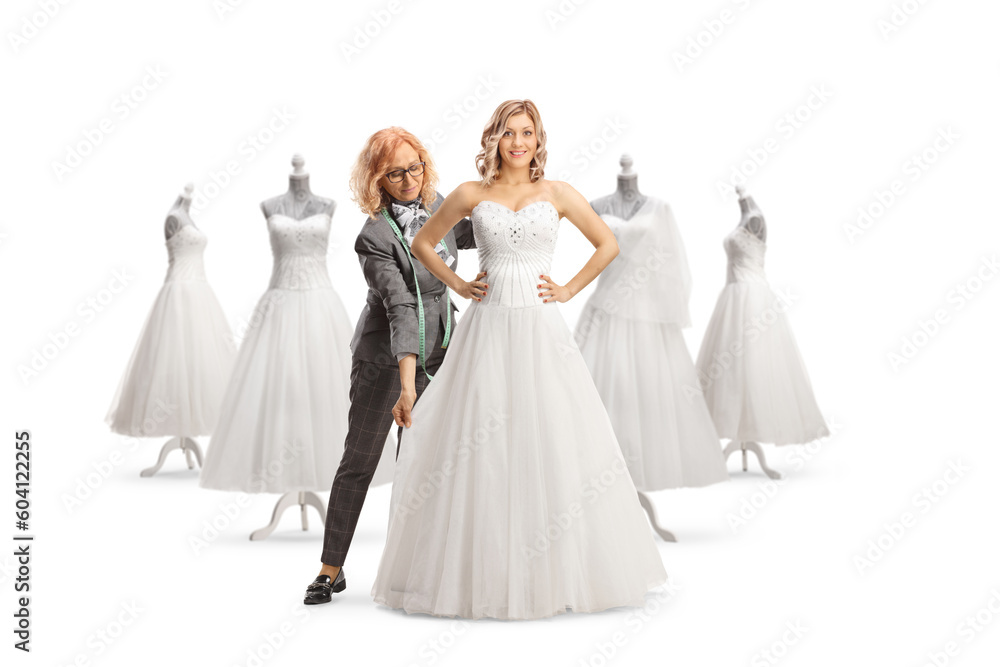 Fashion designer taking measures for a bridal dress