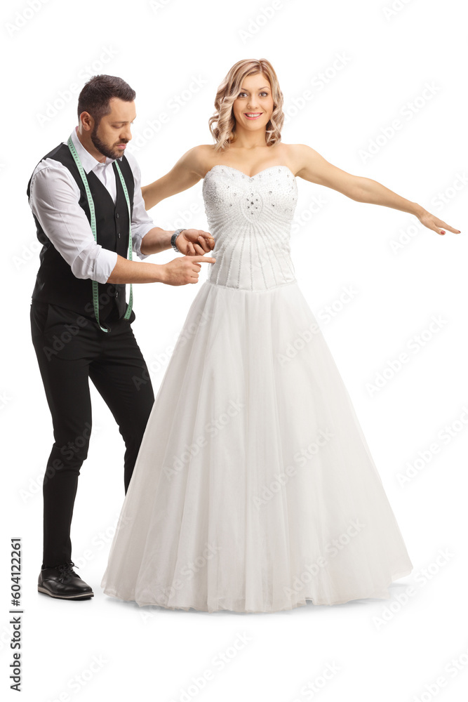 Tailor taking measures for a bridal dress
