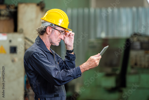 one professional engineer worker technician assistant in helmet inspection check old machine construction factory with colleague manager. check old machinery production construction operating