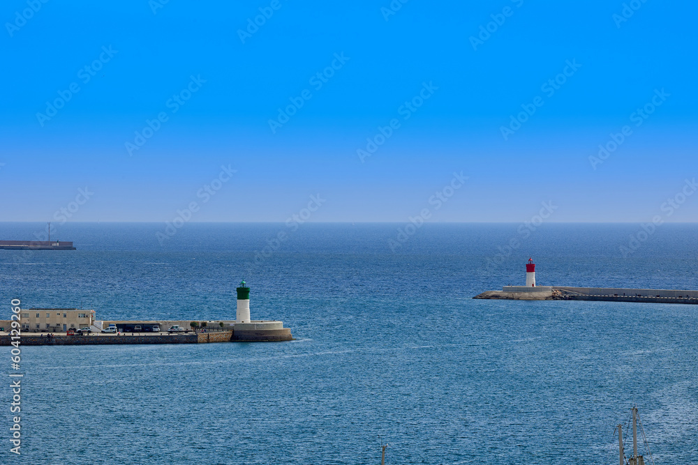 The two red and green lighthouse beacons at the entrance to the port