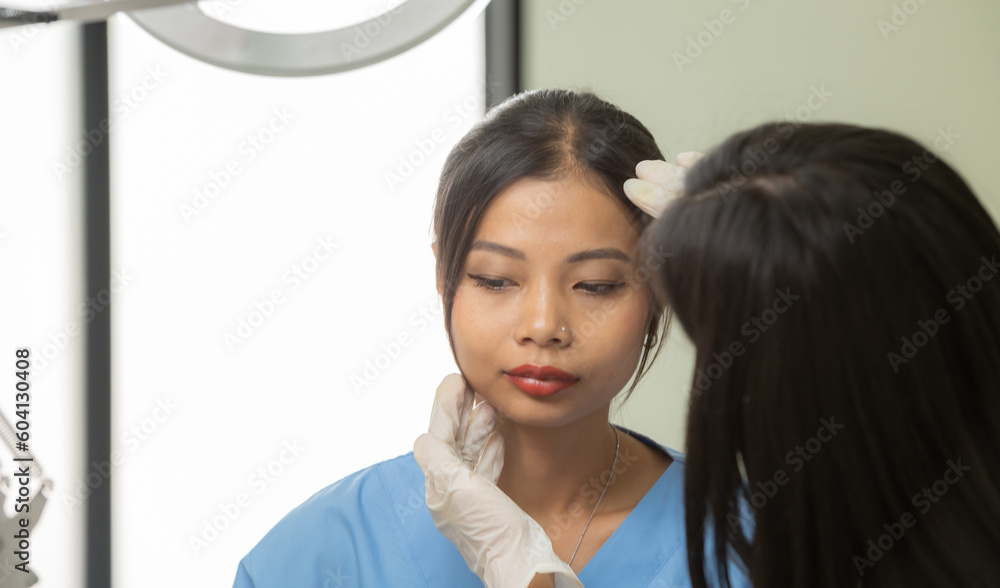 Woman Doctor Gently use hand syringe careful inject iller Botox liquid through skin patient for cosmetic beauty at cosmetic surgery department in hospital clinic. Woman Doctor Gently use hand syringe careful inject iller Botox liquid through skin patient for cosmetic beauty at cosmetic surgery department in hospital clinic.
