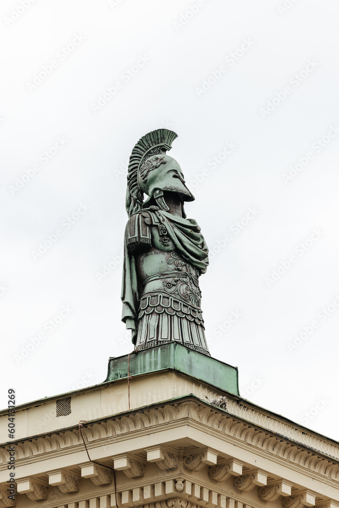 Greek warrior statue on top of the gate of the Hofgarten in Munich, Germany on a cloudy day