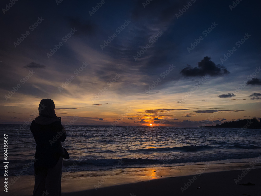 the beauty of the sunset on the beach of lampuuk aceh besar, aceh province, one of the favorite beaches of tourists to enjoy the beauty of nature