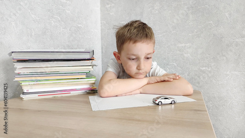 Bilde på lerret Tired boy with ADHD is bored in class, distracted, does not want to do homework