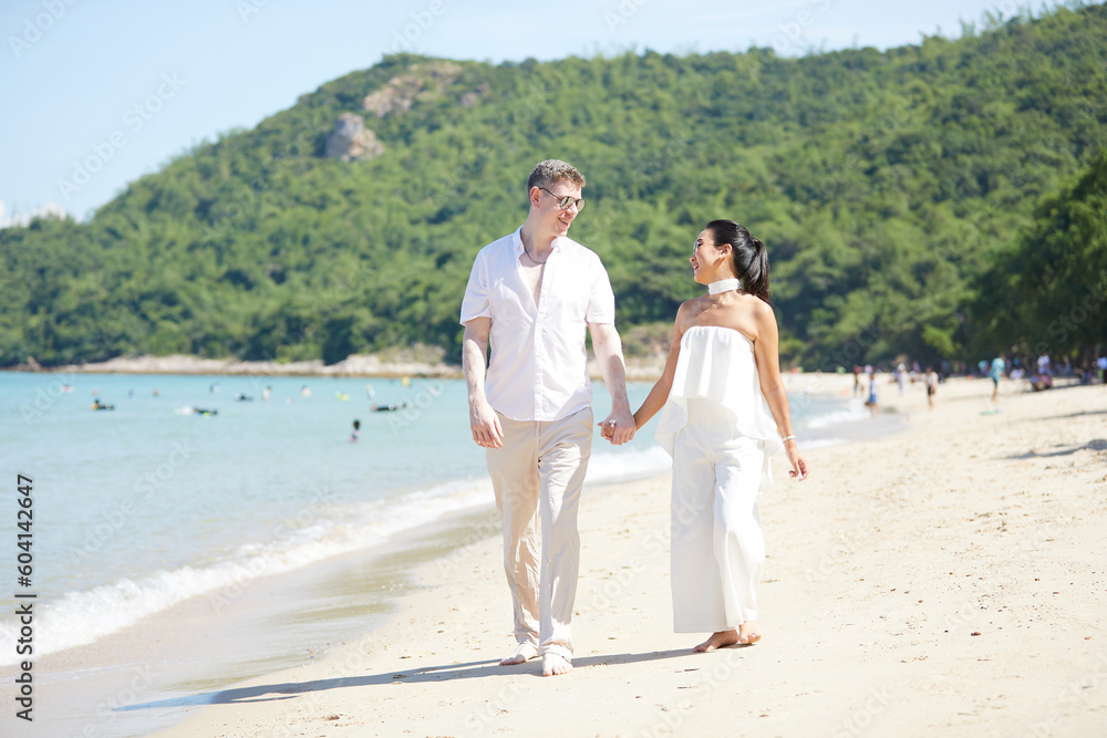 young couple walking on the beach and enjoy to travel in summer