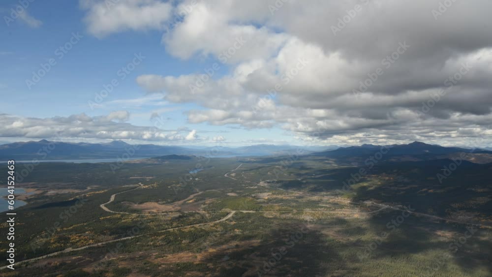 Mountain top view in northern Canada with timelapse video view. Clouds moving across the mountains, lake and wilderness below. Mountain top view in northern Canada with timelapse video view. Clouds moving across the mountains, lake and wilderness below.