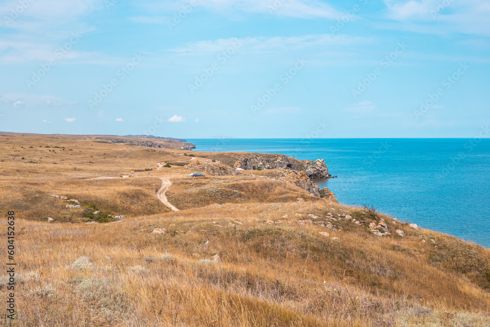Plateau with dry grass and mountainous coast of the Sea of Azov. Seascape. Plateau with dry grass and mountainous coast of the Sea of Azov. Seascape.