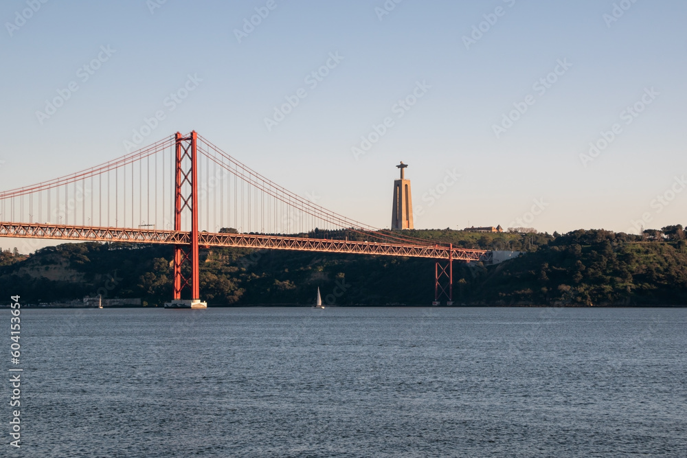 Naklejka premium View of Ponte 25 de Abril Bridge at sunset, Lisbon, Portugal on the Tagus River