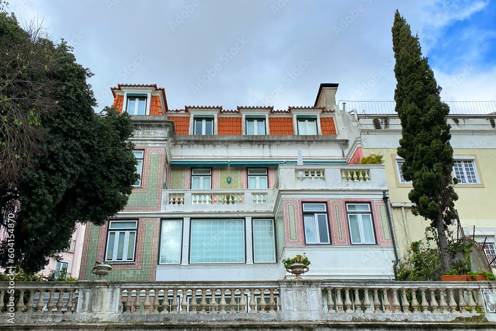 Obraz premium Lisbon, Portugal, facade of an old house with windows, European historical buildings, cozy cityscape, Portuguese streets landscape, view of city