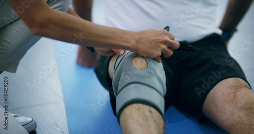 Physiotherapy, training and knee with a bandage after injury, accident or rehabilitation. Help, fitness and hands of a doctor with a brace for leg of a patient for muscle care, recovery and health photo