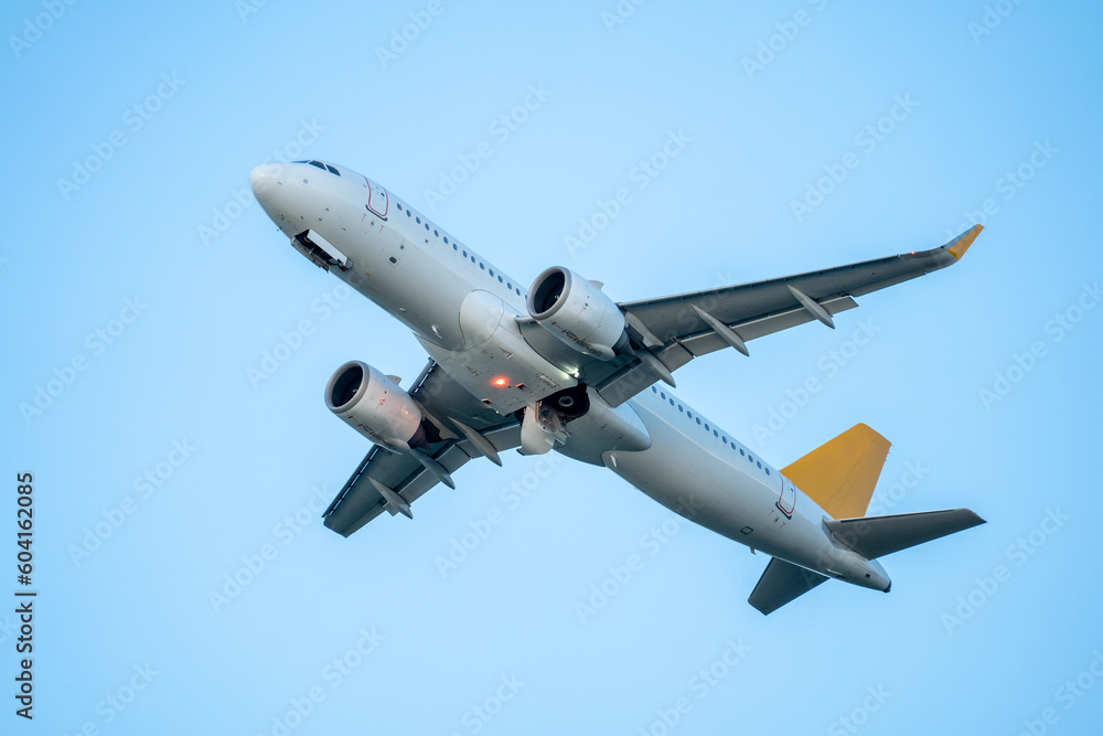 Passenger airplane flight in blue sky bottom view. Airplane fly high in clear sky. Travel concept. Passenger airplane flight in blue sky bottom view. Airplane fly high in clear sky. Travel concept.