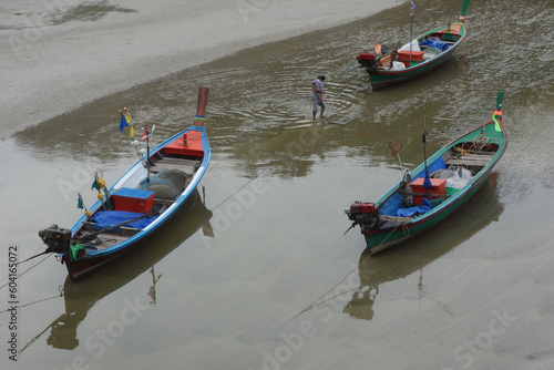 Colorful wooden boats in shallow water, peaceful seascape, Asian landscape