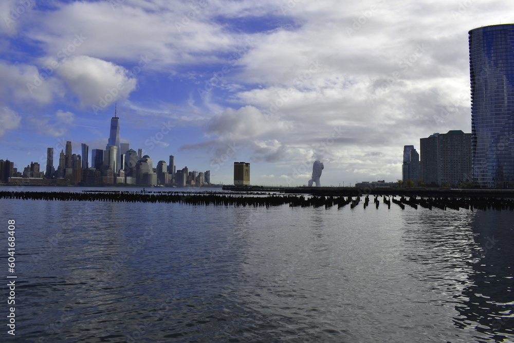 Manhattan skyscrapers view from the water, modern architecture of New York City landscape from the waterfront Manhattan skyscrapers view from the water, modern architecture of New York City landscape from the waterfront