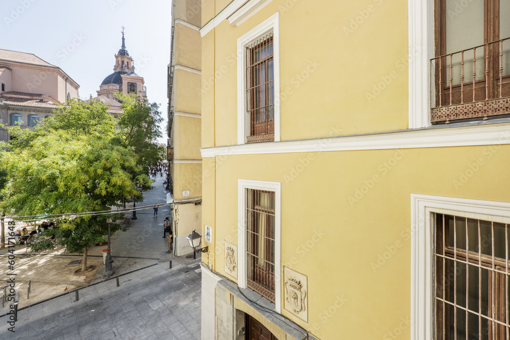 Facades of old residential buildings and domes of a church in the historic center
