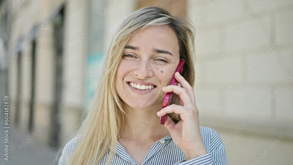 Young blonde woman smiling confident talking on smartphone at street Young blonde woman smiling confident talking on smartphone at street