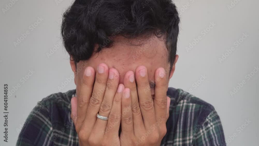 Young man Indonesia stress and disappointed expression with white background. The footage is suitable to use for advertising and expression content media. Young man Indonesia stress and disappointed expression with white background. The footage is suitable to use for advertising and expression content media.