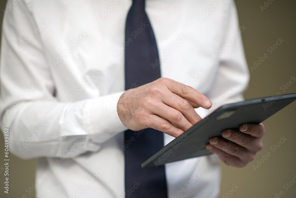 business person working with laptop and tablet in the office, talking on the phone and evaluating work business person working with laptop and tablet in the office, talking on the phone and evaluating work