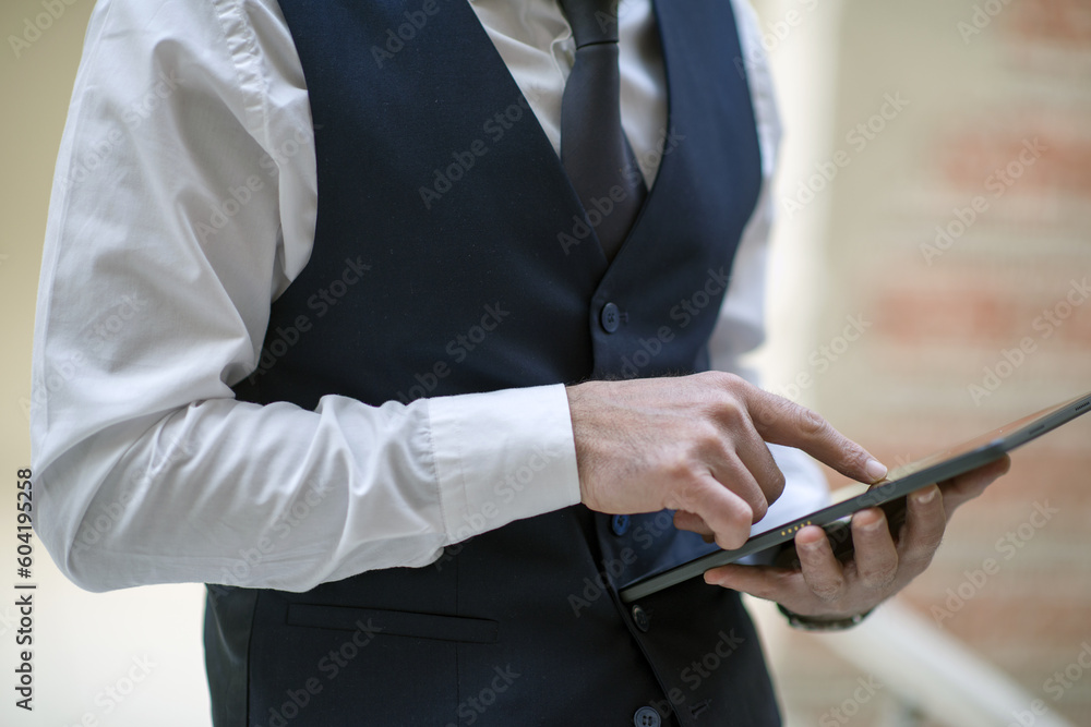 business person working with laptop and tablet in the office, talking on the phone and evaluating work business person working with laptop and tablet in the office, talking on the phone and evaluating work