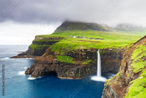 The iconic waterfall of Mulafossur, Gasadalur, Vagar, Faroe islands, Denmark, Northern Europe