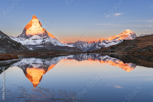 Matterhorn reflection in Riffelsee lake at sunrise, Gornergrat, Zermatt, canton of Valais, Switzerland photo