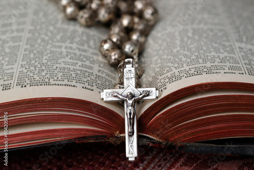 Vintage rosary with crucifix on an open Bible, Christian religious symbol, France photo