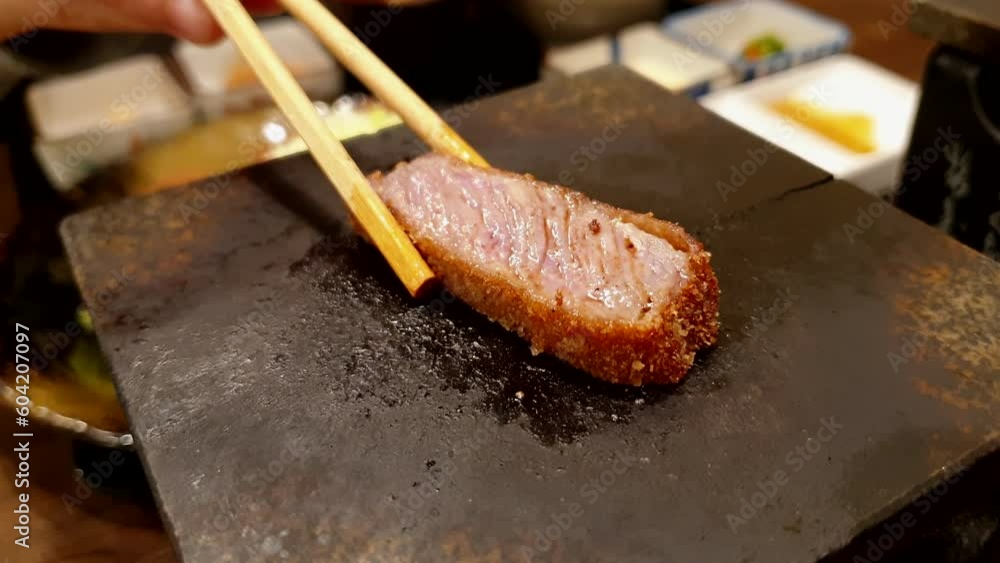 chopsticks grilling gyukatsu hot plate Japanese food beef loin fried