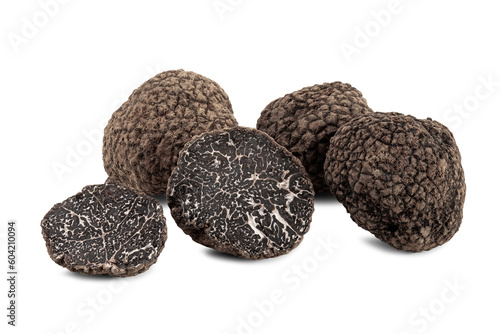 black truffles with slices on white background.