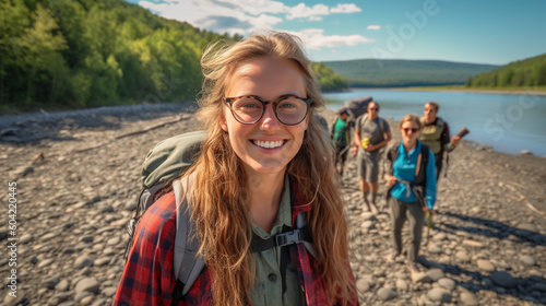 young adult woman with friends in european nature ,fictional place, having fun by river in nature at fields in rural, having fun and joy in hiking and exploring as adventure in vacation