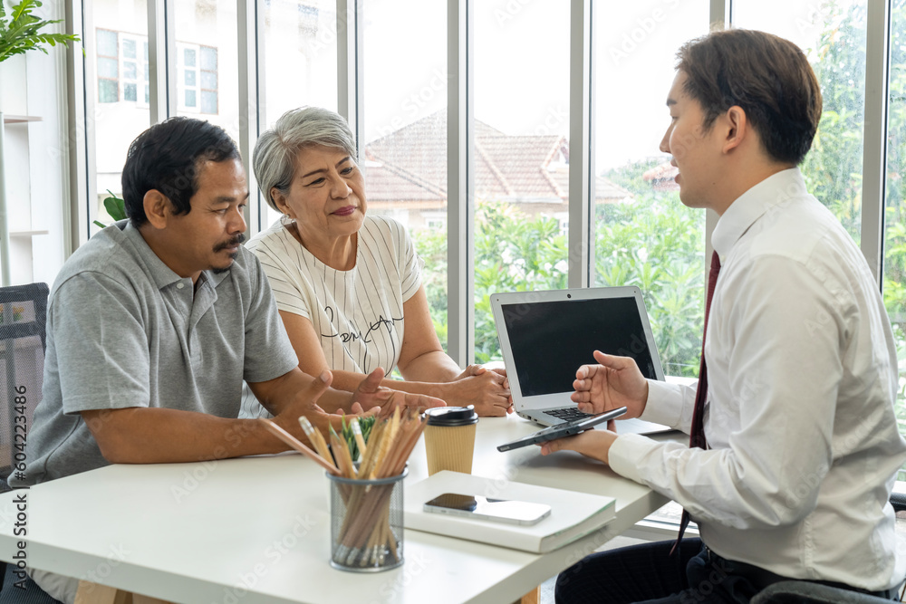 Asian young employee is offering about life insurance plan to aged couple Asian young employee is offering about life insurance plan to aged couple
