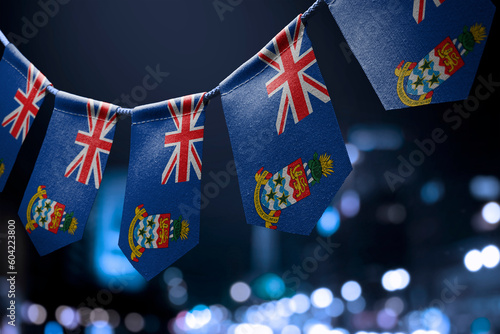 A garland of Cayman Islands national flags on an abstract blurred background photo