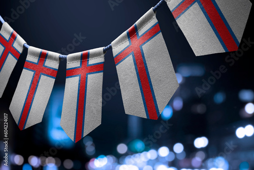 Fototapeta Naklejka Na Ścianę i Meble -  A garland of Faroe Islands national flags on an abstract blurred background