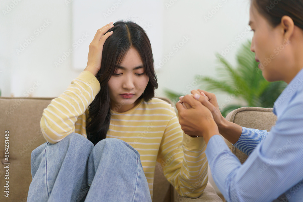 Female psychologist touching hands to comforting and encourage stress patient suffering depression - obrazy, fototapety, plakaty 