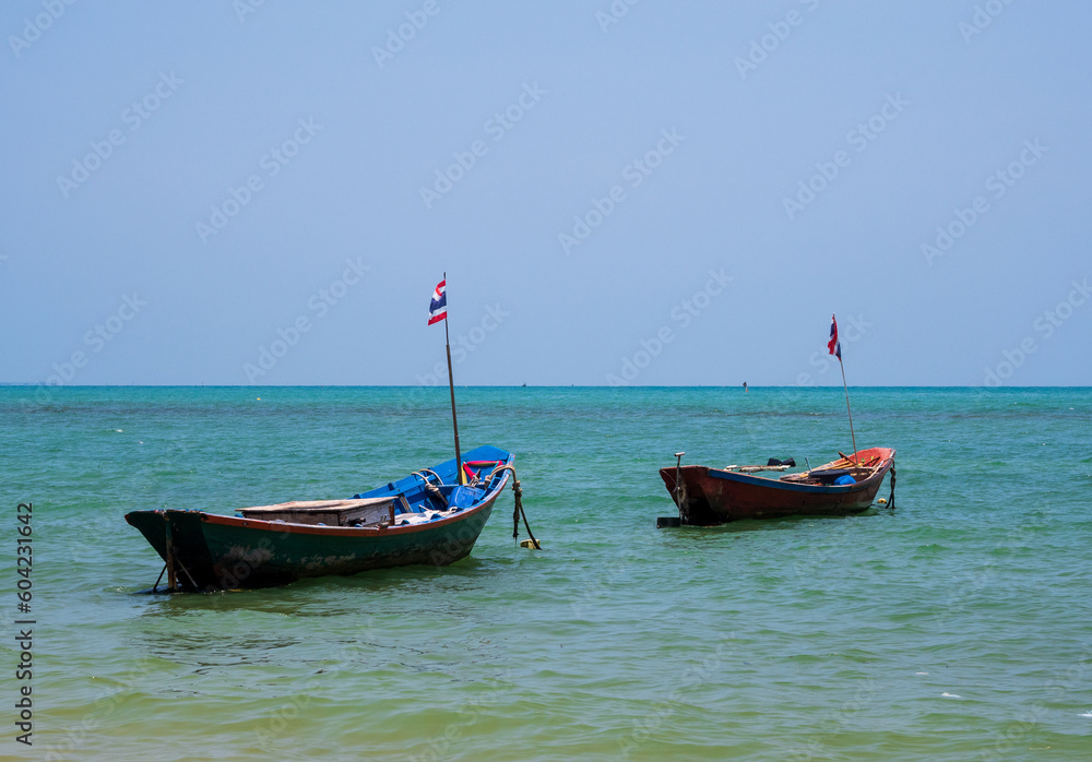 landscape look view point Small fishing boat wooden parked coast sea beach. after fishing of fishermen in small village It small local fishery. Blue sky, white clouds clear weather