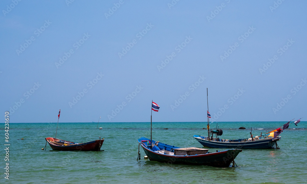 landscape look view point Small fishing boat wooden parked coast sea beach. after fishing of fishermen in small village It small local fishery. Blue sky, white clouds clear weather