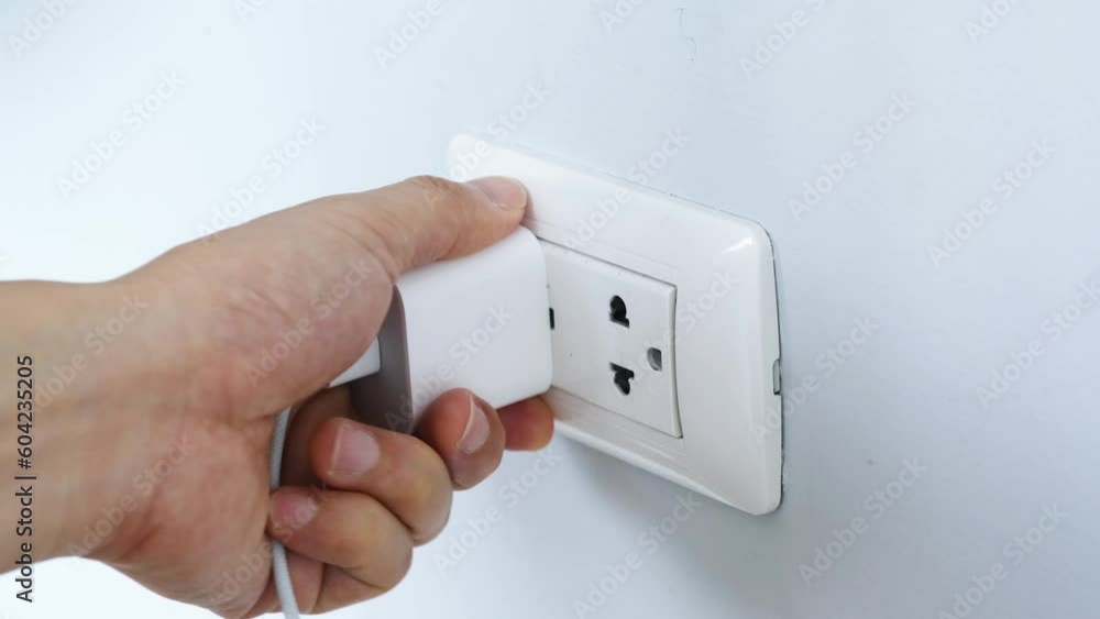 Hand of Electrical Appliances He was pulling the plug. Out of the plug. In his office during work hours. Energy Saving Concepts and Technologies Hand of Electrical Appliances He was pulling the plug. Out of the plug. In his office during work hours. Energy Saving Concepts and Technologies