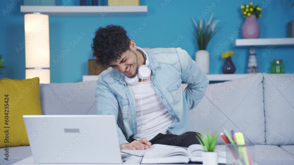 College student suffering from back pain. College student suffering from back pain.
