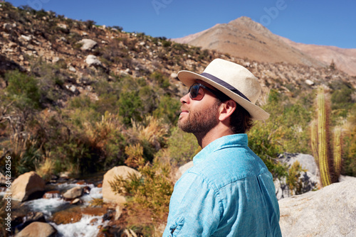 portrait mid adult caucasian male contemplating the beauty of the landscape in Elqui Valley © oscargutzo