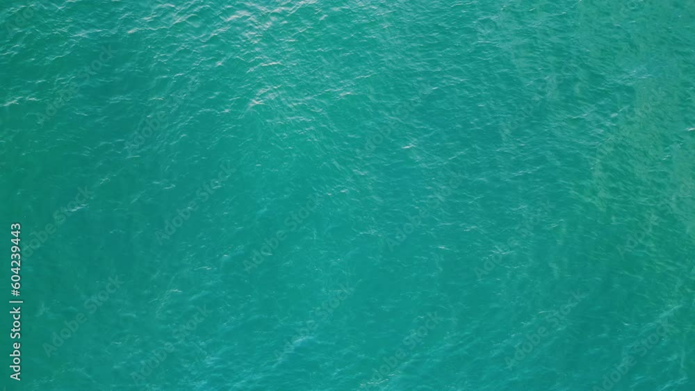 Turquoise water waving agitated aerial view. Blue sea surface making small waves Turquoise water waving agitated aerial view. Blue sea surface making small waves