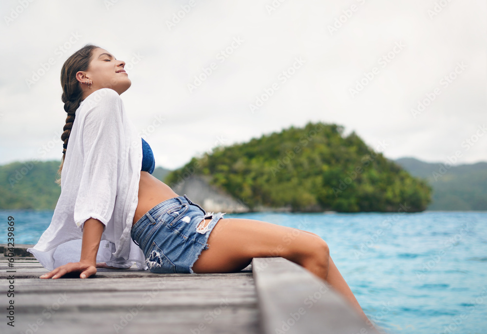 Relax, vacation and woman with boardwalk, happiness and tropical island for break, stress relief and peace. Female person, girl or tourist with seaside holiday, getaway and travel with water and deck
