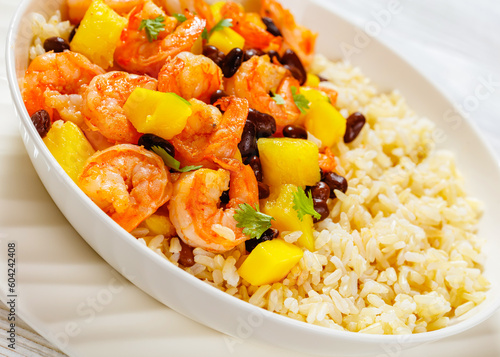 shrimps with beans, mango, brown rice in bowl