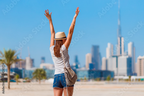 Tourist vacation woman on beach and skyscrapers background. Dubai, UAE