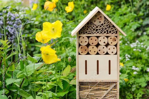 An insect hotel or bee hotel in a summer garden. An insect hotel is a manmade structure created to provide shelter for insects in a variety of shapes and sizes and materials.  © Harry Wedzinga
