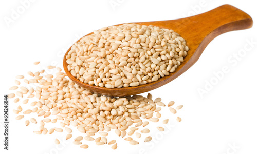 Roast white sesame seeds in the wooden spoon, isolated on white background.