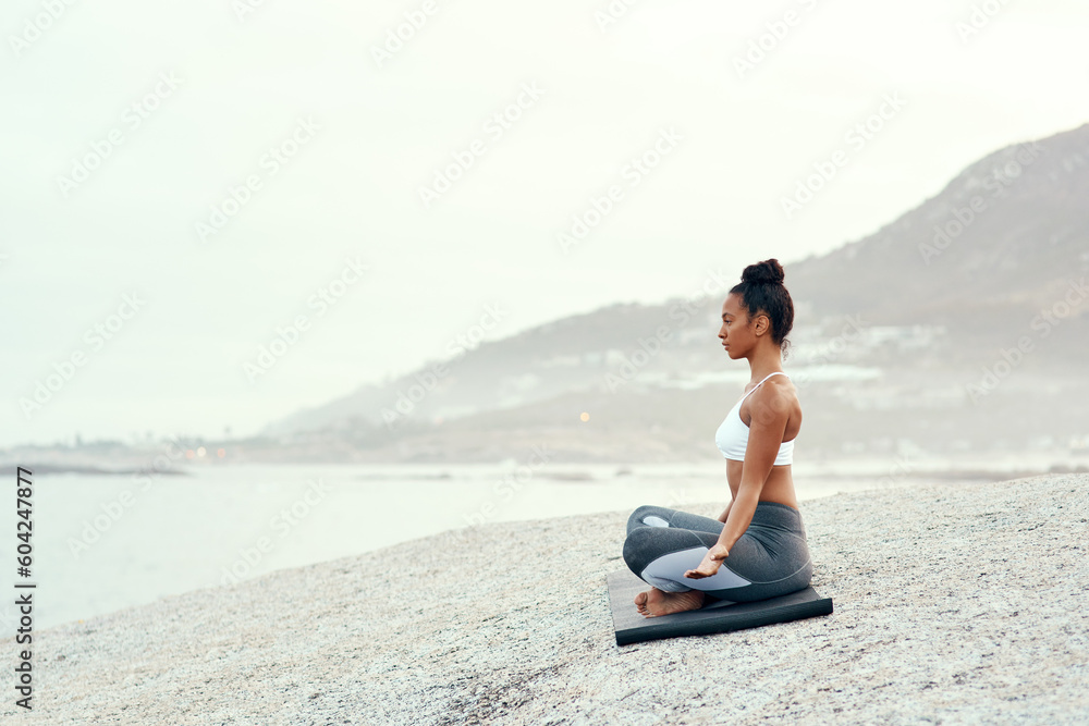 Yoga, outdoor meditation and woman on a beach with lotus pose, wellness and fitness. Pilates, sea and young female person on sand with peace in nature feeling relax and calm with spiritual mockup