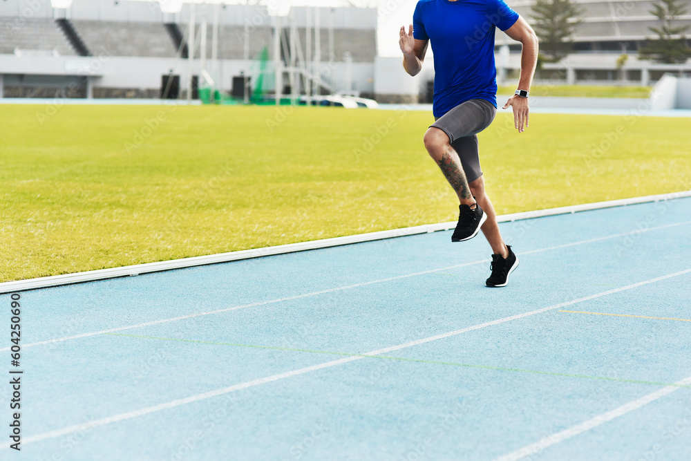 Man, legs and running on track for fitness, workout or exercise of athlete training at the stadium. Leg of male person or runner exercising in run, athletics or sports competition for healthy cardio